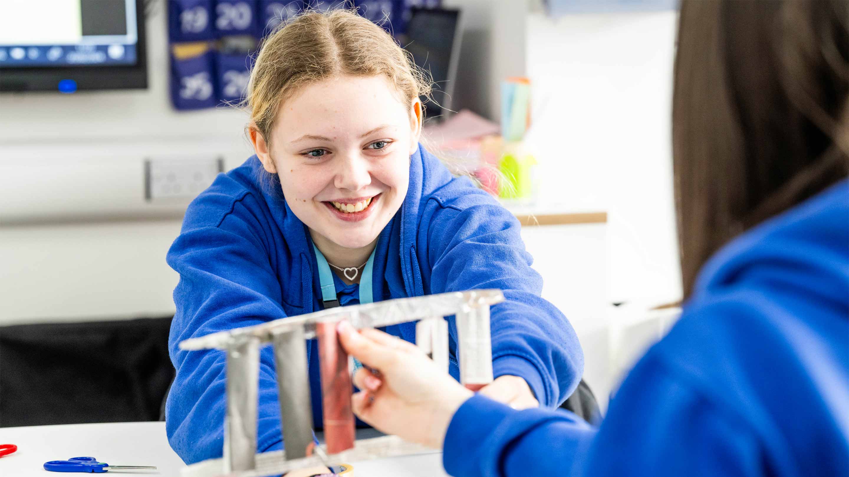Childcare students at a table doing craft activities