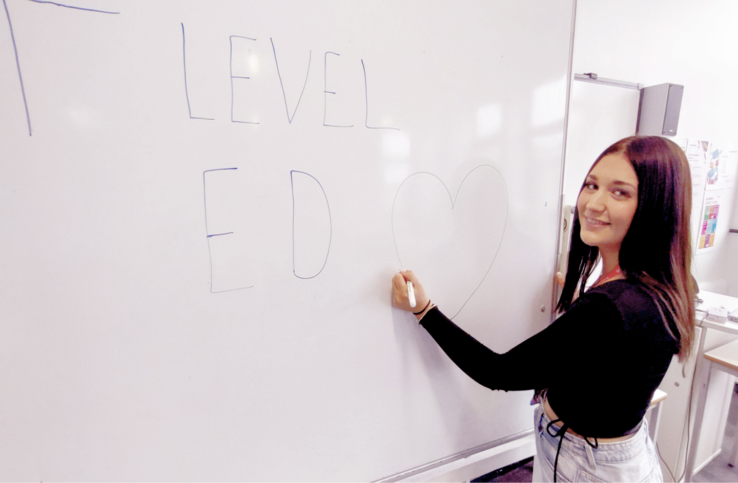 Chloe Leslie T Level in Level 3 Education and Childcare student writing on a white board