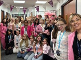 Staff and students gather in their pink outfits