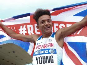 Thomas Young holds a Union flag behind him