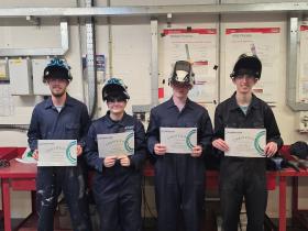 Welding students with their certificates of Masterclass completion