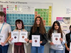 Chemistry students hold their certificates from the Olympiad