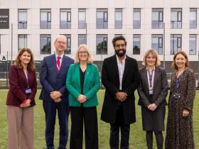 Corrie Harris, Stephen Smith, Minister Jacqui Smith, MP Jeevun Sandher, Helen Van Aardt, and Rachel Pringle stand in front of the Loughborough College Sports Centre