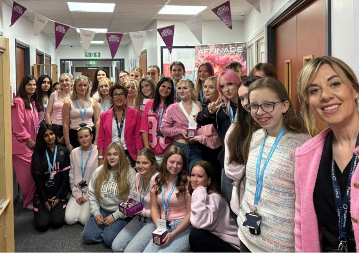 Staff and students gather in their pink outfits