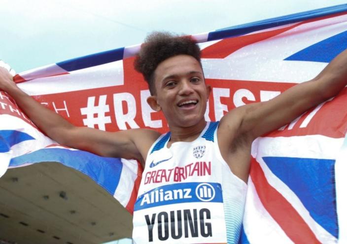 Thomas Young holds a Union flag behind him