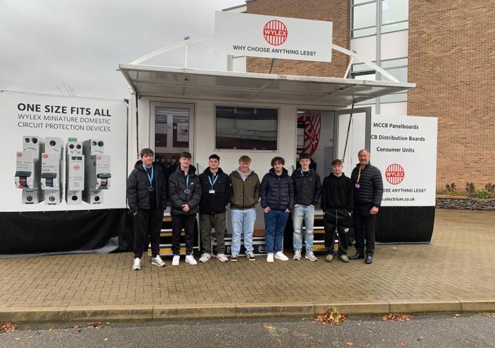 Students and staff stand outside the mobile showroom