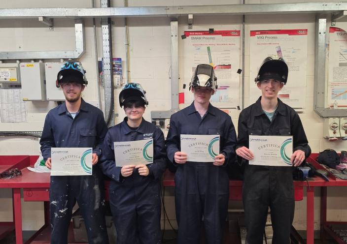 Welding students with their certificates of Masterclass completion