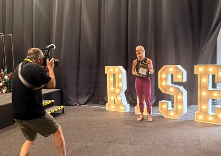 A RISE winner gets their photograph taken