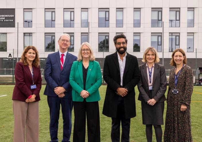 Corrie Harris, Stephen Smith, Minister Jacqui Smith, MP Jeevun Sandher, Helen Van Aardt, and Rachel Pringle stand in front of the Loughborough College Sports Centre