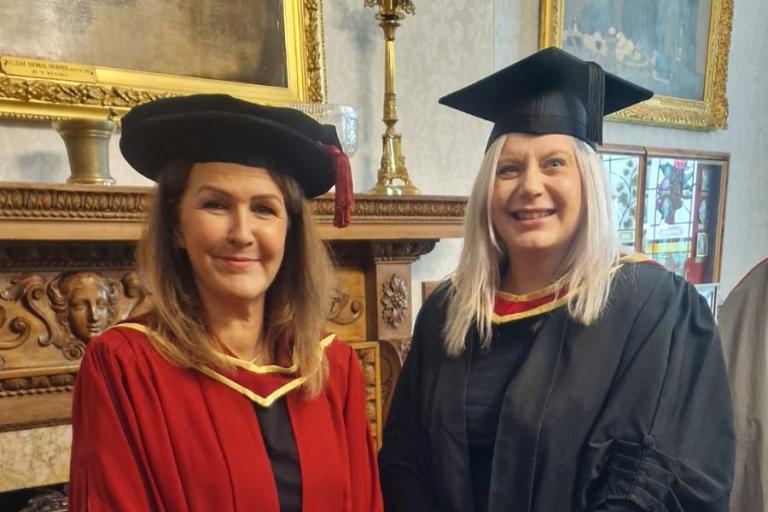 Two people in Graduation gowns