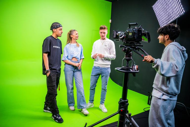 Students in the media green screen room
