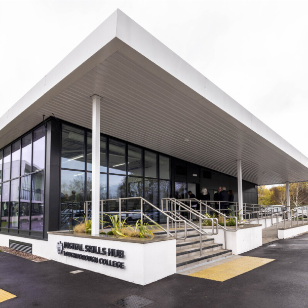 Exterior of the Digital Skills Hub, a glass-fronted building with a white porch and steps at the entrance