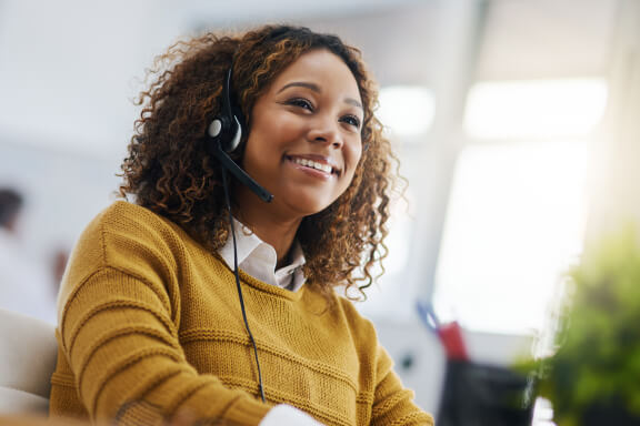 Support staff member using a headset to answer a phone call