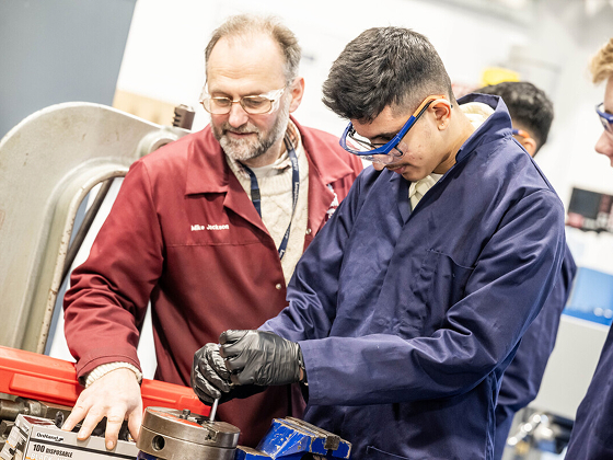 Student with his hands on machinery