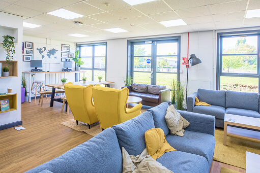 Interior of the HE common room at Loughborough College showing relaxing and study areas