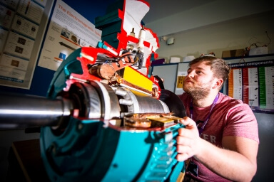 Engineering student looking at a cross section of a motor
