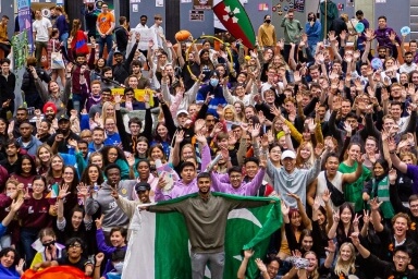 Hall full of students cheering at the LSU freshers fair