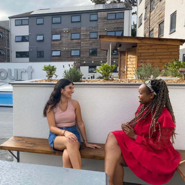 Two students smiling outside Forest Court, a Student Beehive accommodation
