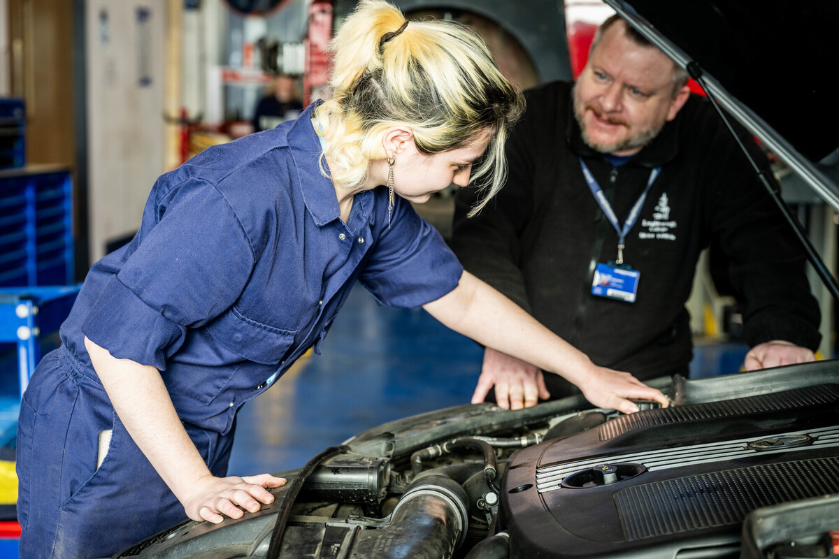 Apprentice working on a car
