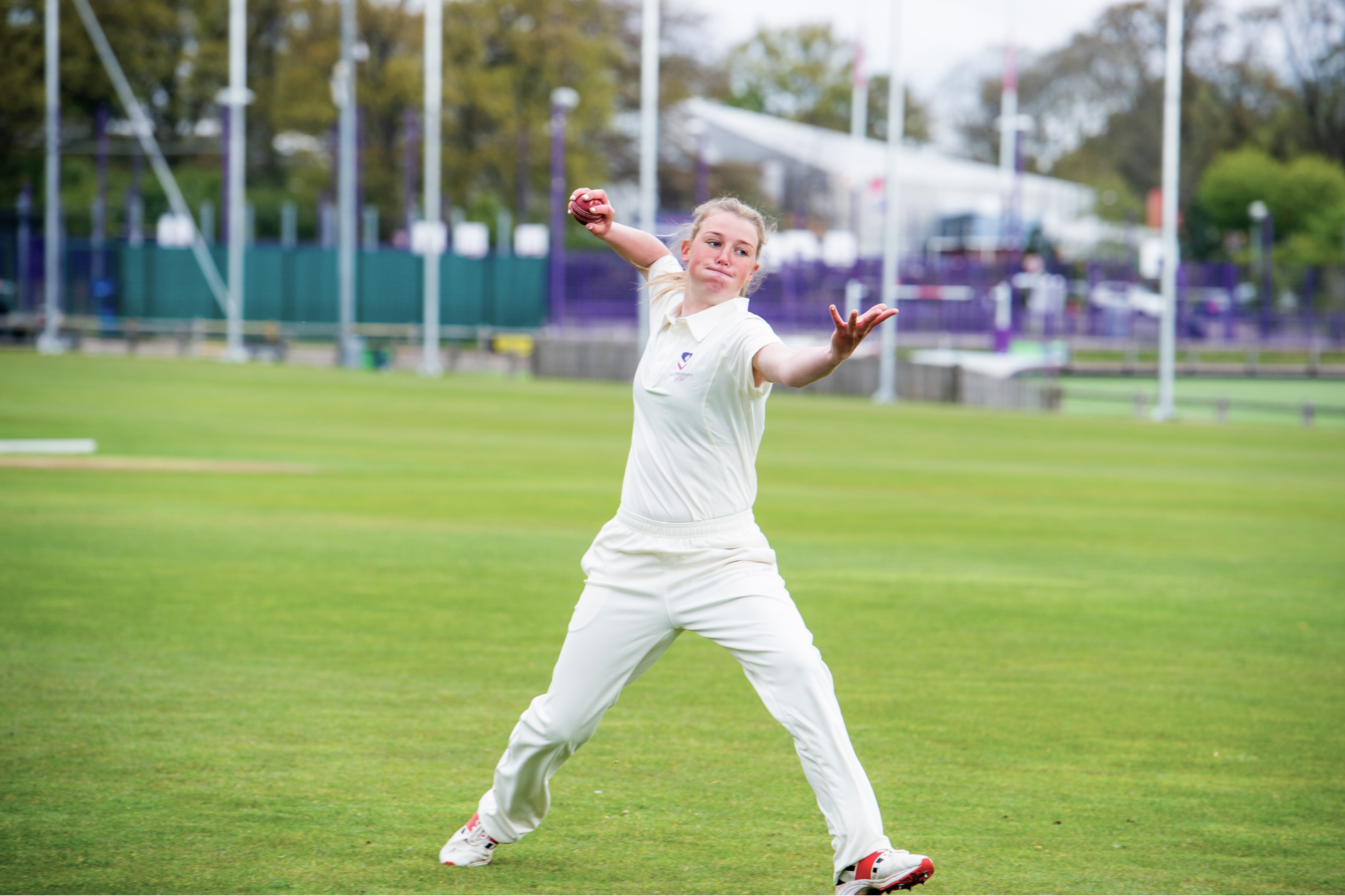 A cricket player bowling.