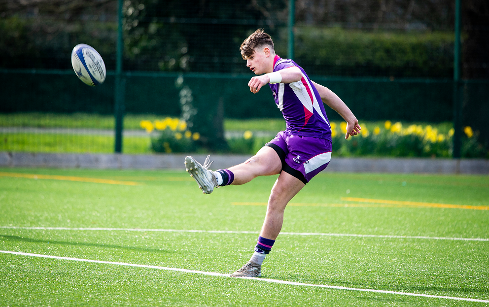 Rugby player kicking a ball