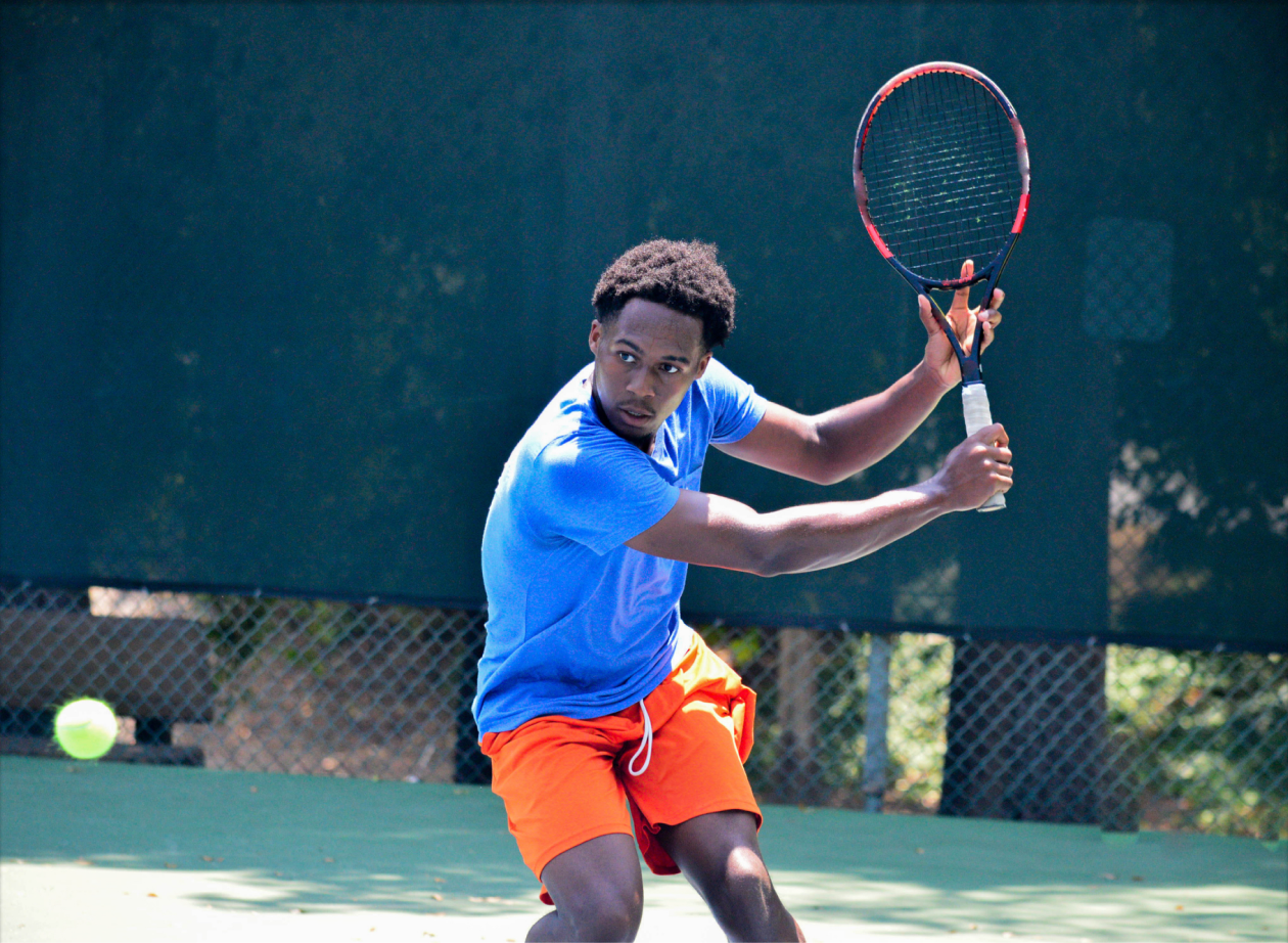 A tennis player mid-swing