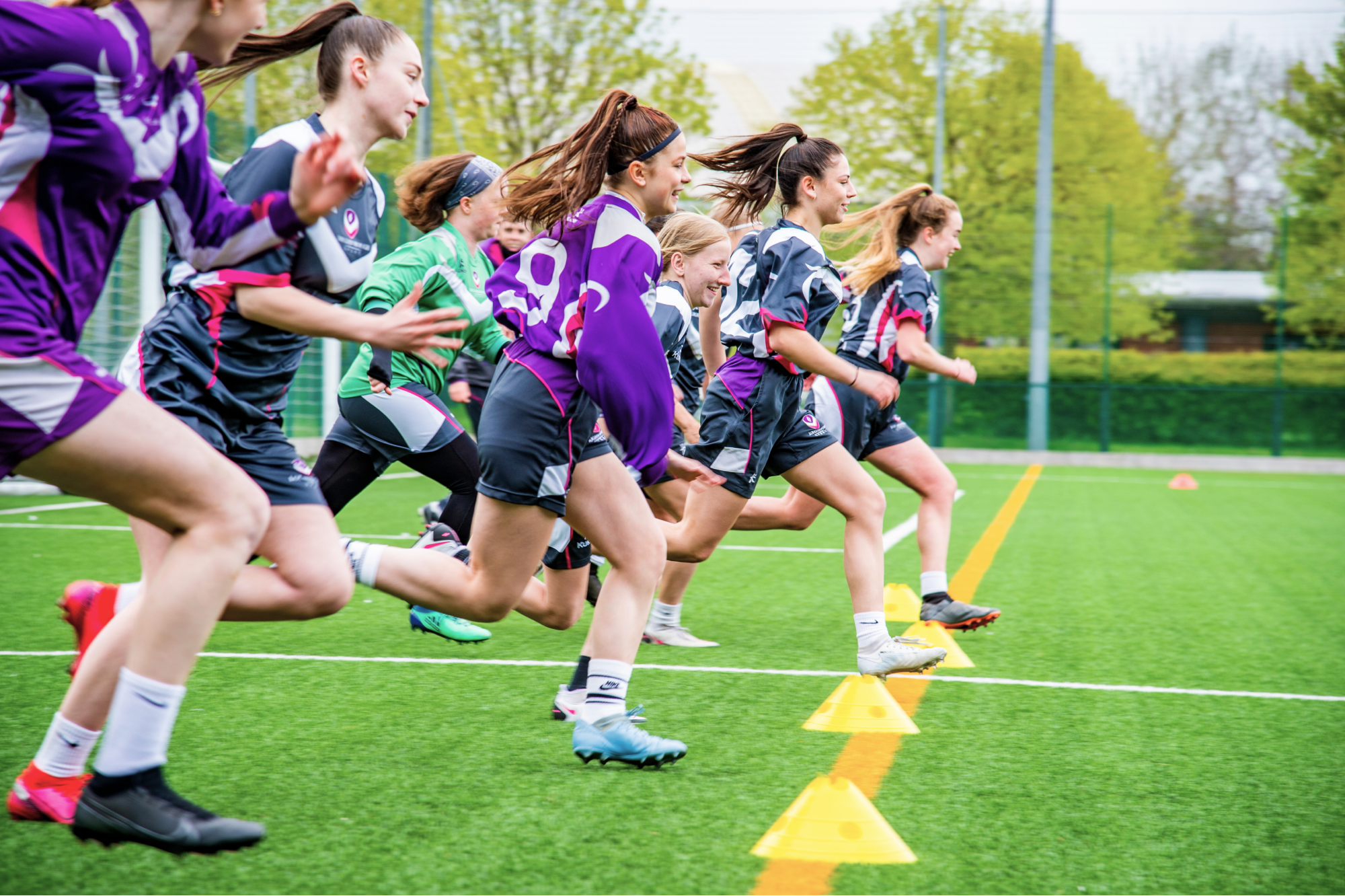 A group of footballers running during a training session.