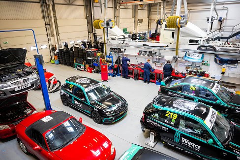 A high view of the motor vehicle workshop at Stephenson College showing car bays, work benches and car storage
