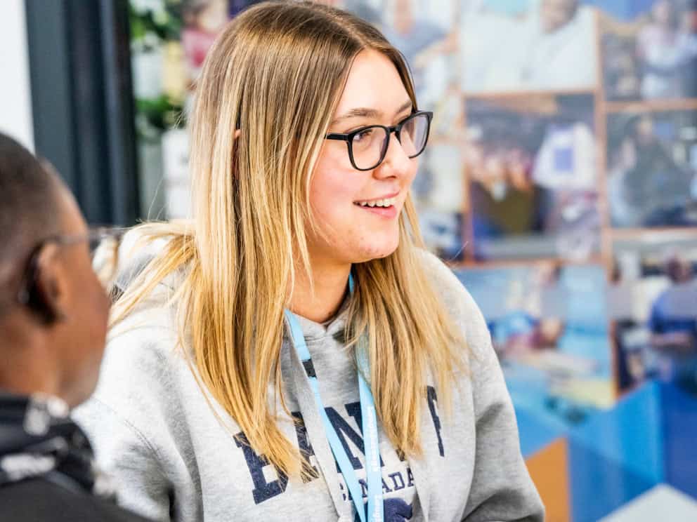 Student sitting at a table talking to a careers advisor